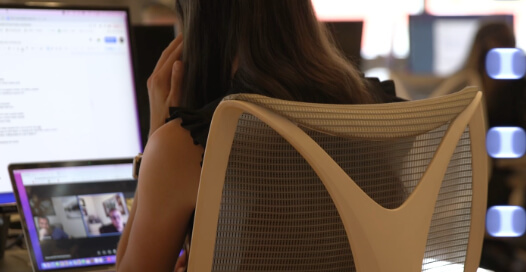 A Rocket55 team member works with others on a video meeting